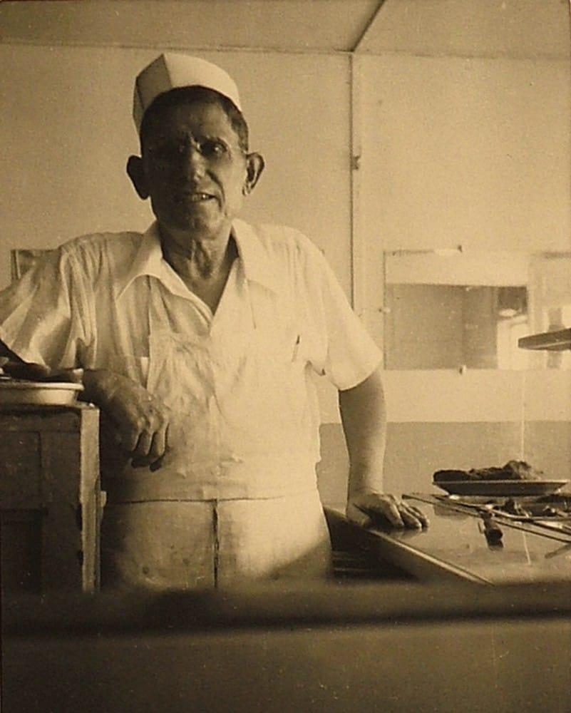 Frank Demeris standing in a restaurant kitchen