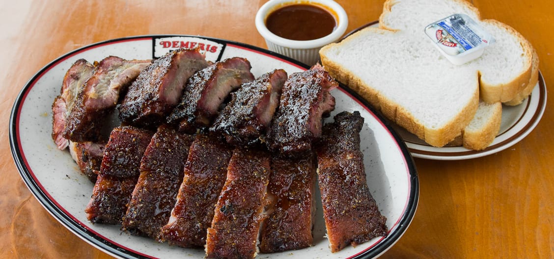 Full slab of Baby D's baby back ribs with sauce and white bread